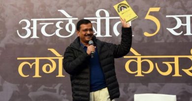 Delhi Cheif Minister Arvind Kejriwal holds a copy of AAP Ka Report Card during the first town hall meeting at the Constitution Club of India in New Delhi.