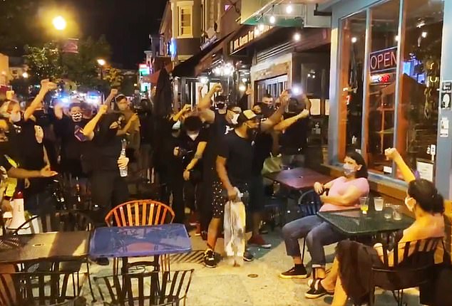 BLM protesters outside a restaurant in Washington DC on Monday as part of protests following the shooting of Jacob Blake in Wisconsin