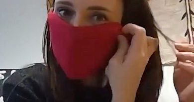 New Zealand Prime Minister Jacinda Ardern demonstrates how she makes an improvised face mask during a video meeting with local community health leaders