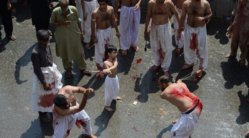 A group of Shiite Muslims swing swords and chains around to complete the ritual of self-flagellation to mark Ashura