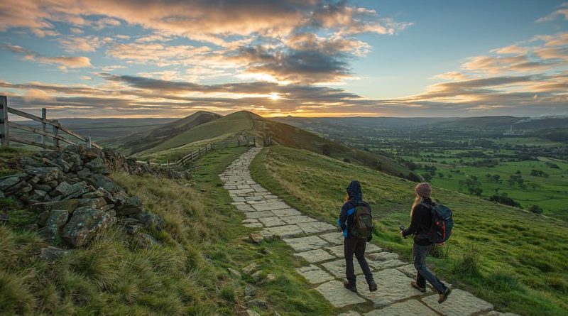 Temperatures are set to plunge as low as 10C in parts of the UK - as much as 5C below the average. Pictured are a pair walking through the early morning sunshine in Lose Hill, Peak District