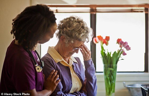 Over the first 16 weeks of the outbreak, there were 79 per cent more deaths in care homes than seen on average in the previous five years in England. Pictured: Stock photo of a care home worker comforting a grieving elderly woman