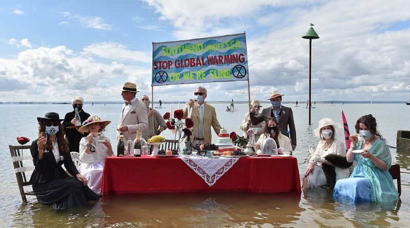 Extinction Rebellion protesters today staged a Titanic-themed dinner party in the sea to shine a light on rising sea levels