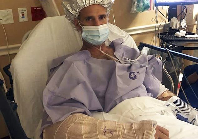 Florida paramedic Carsten Keiffer is pictured in his hospital bed days after being bitten by a 12-foot alligator