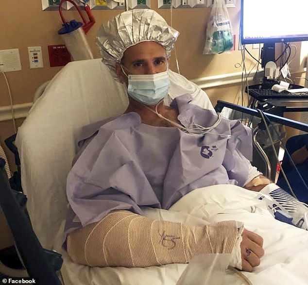 Florida paramedic Carsten Keiffer is pictured in his hospital bed days after being bitten by a 12-foot alligator