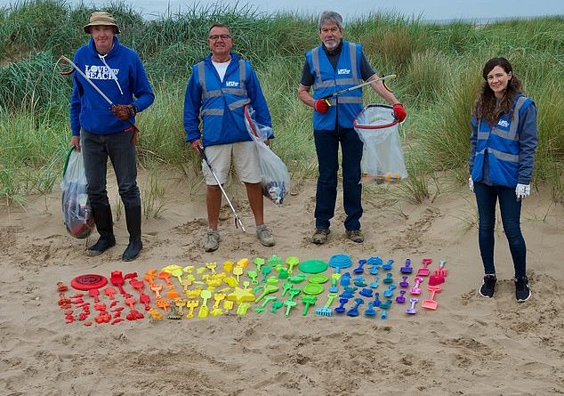 Toy story: Spades, frisbees and moulds lined up on St Annes beach near Blackpool. Volunteers say the cheap toys are increasingly being seen as one-use items to be left behind