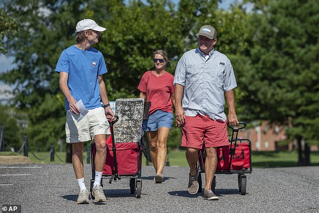 The University of Alabama has had more than 1,200 positive coronavirus cases among students and faculty and employees. A student is seen moving onto campus on August 15