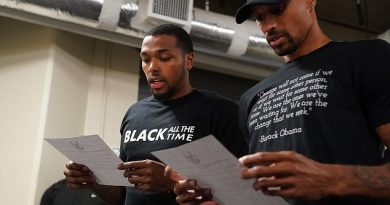 Sterling Brown and George Hill of the Milwaukee Bucks reads a statement to the media