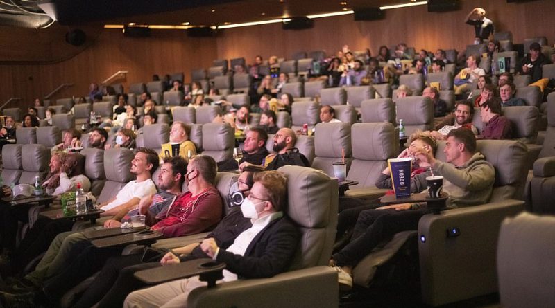 Cinema-goers in face masks are seated in the huge 800-capacity auditorium in Odeon Luxe in Leicester Square, London