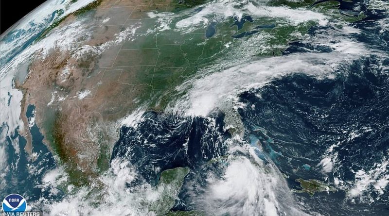 This NOAA satellite image shows Tropical Storm Laura moving south of Cuba (right) and Tropical Storm Marco in the US Gulf Coast (above)