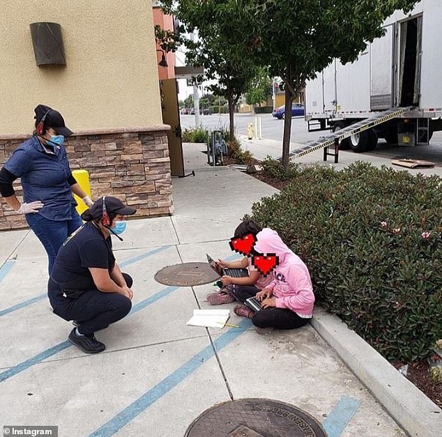 A photo shared to Instagram showed two young children in Salinas, California, sitting outside a Taco Bell so they can use the free Wi-Fi for homework (pictured)