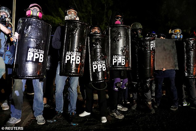 Demonstrators confront police during a protest against police violence and racial injustice in Portland, Oregon, U.S., August 23, 2020. Picture taken August 23, 2020