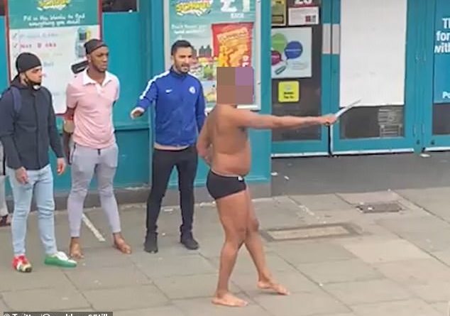 Shocking footage shows a half-naked man threatening shoppers with a large knife outside a Poundland in south London