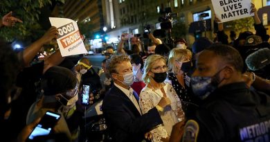 Protesters surround Senator Rand Paul of Kentucky and his wife as they left the Republican National Convention late Thursday. He said he was attacked by an
