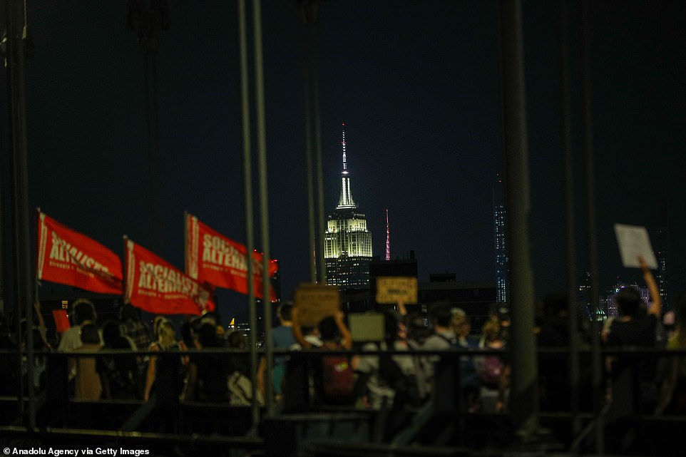 The Empire State Building is lit up as demonstrators walk through New York City in the wake of Wednesday's decision