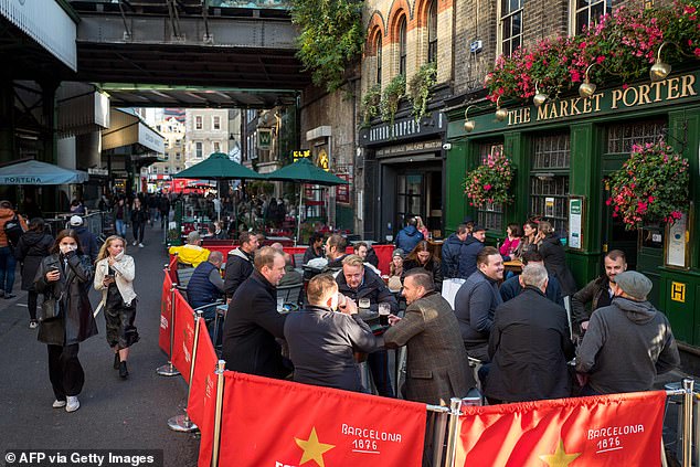 The nation's struggling hospitality sector recorded just 22 outbreaks of respiratory infections - including Covid-19, a drop of 12 from the total identified from September 14 to 20 (Pictured: Pubgoers in London's Borough Market last week)