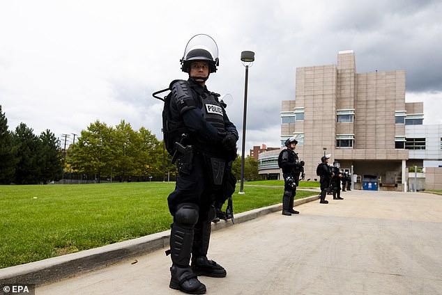 Police line up in front of the debate hall in Cleveland