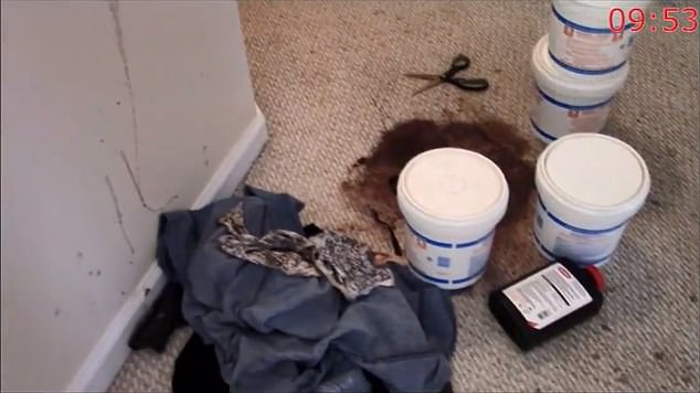 Containers of chemicals are seen sitting in a hallways next to a large bloodstains