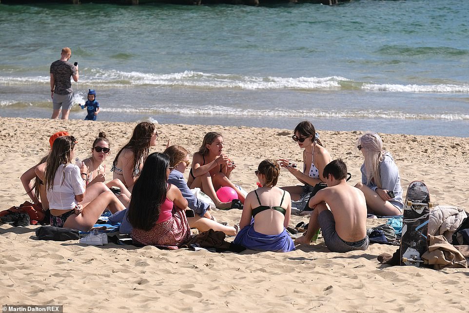 After putting up with damp and chilly weather, Britain is set to enjoy an Indian summer next week, with temperatures set to hit the 80s. Pictured: Beachgoers in Bournemouth on Tuesday