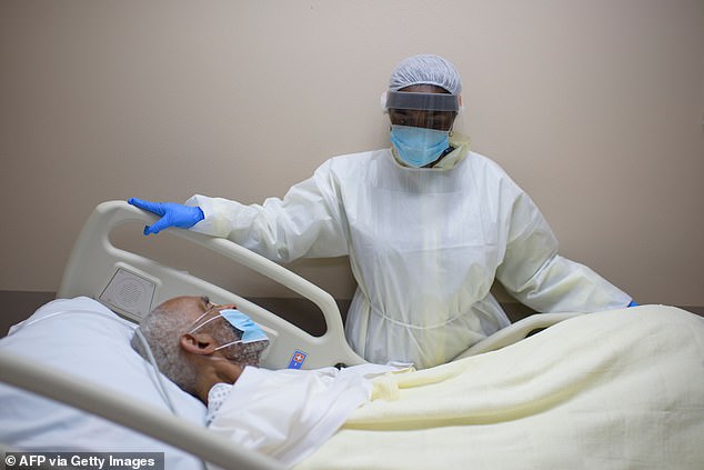 The latest CDC data reveals that just 6% of people who have died of COVID-19 in the US died of coronavirus alone, while 94% of death certificates listed other diseases as well. Pictured: a Houston health care worker tends to a patient at United Medical Center