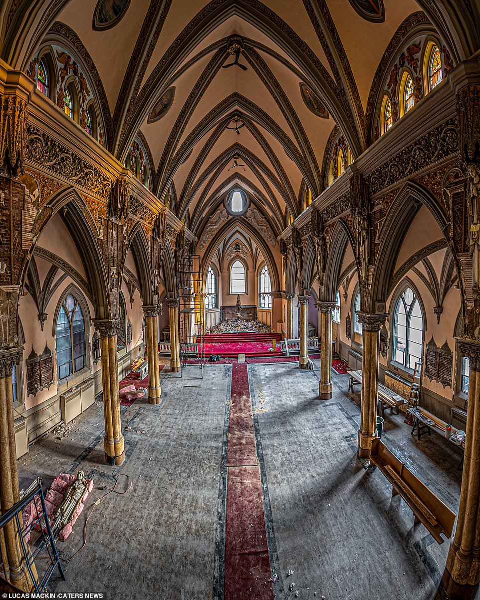 Photographer Lucas Mackin, 25, regularly travels across New England from his home in Connecticut in search of once-grand buildings now left to decay. Pictured, an abandoned church had been gutted of its pews and altar. An aisle can still be made out through the centre of the buildings and debris is littered where the vicar once stood. Despite the state of disrepair, an ornate ceiling and stunning stained glass remain untouched
