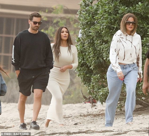 Wrapping it up: Kim Kardashian West (M), her sister Khloé (R), and pseudo brother-in-law Scott Disick (L) filmed Keeping Up with the Kardashians in Malibu on Friday - three days after announcing the show will end next year