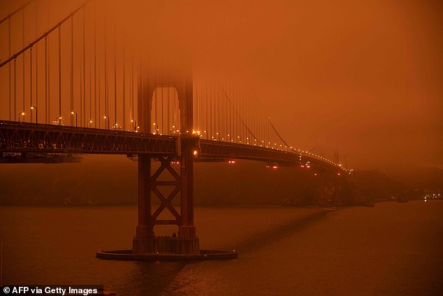 More people are leaving California than arriving, driven out by worsening wildfires, power outages, and the skyrocketing cost of living. Cars drive along the Golden Gate Bride under a haze of orange smoke in San Francisco on September 9