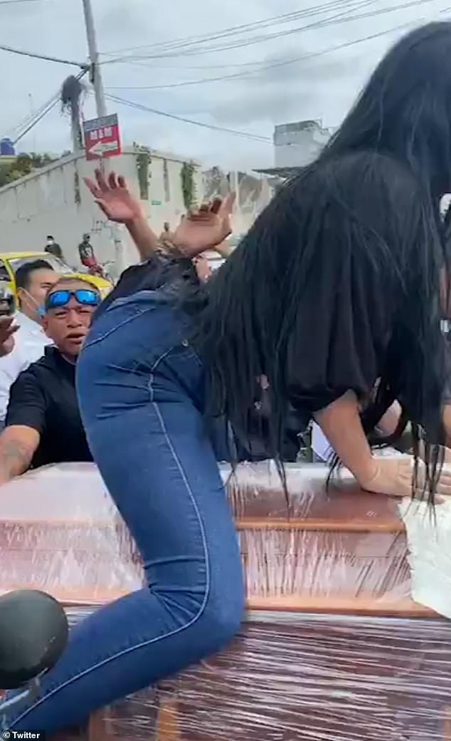 The woman in the video can be seen twerking on top of the coffin, in front of a cheering crowd