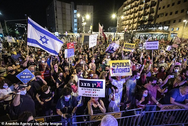 Demonstrators gather to stage a protest against Israeli Prime Minister Benjamin Netanyahu, demanding his resignation over corruption cases and his failure to combat the coronavirus pandemic in West Jerusalem on September 5