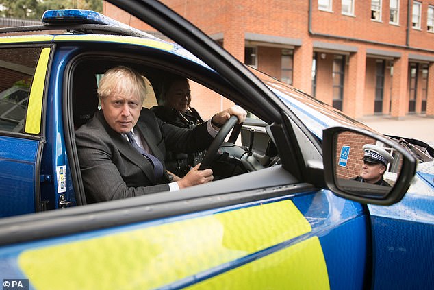 While his economic chief was explaining the successor to the furlough scheme, Mr Johnson was at a police training centre, posing for pictures
