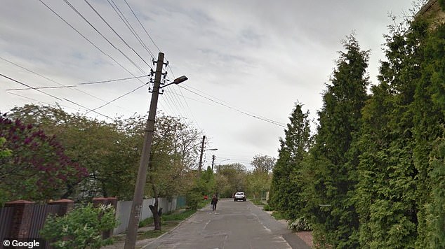 The badly-beaten victim was discovered by a passer-by in a park near the railway tracks on Tolbukhin street (pictured) in the Shevchenko district of the Ukrainian capital. Police said a search is under way for a male suspect