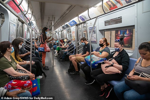 Academics argue such cleaning measures were not in place during the early days of the pandemic, which is what helped spread the virus. Pictured: People ride the L train subway during rush hour in New York City, June 8