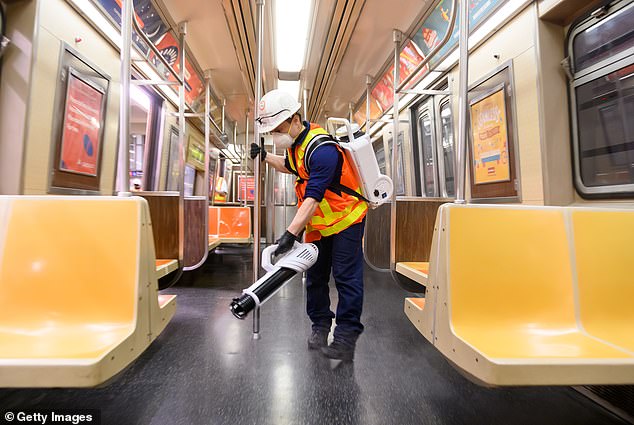Millions of dollars have been spent cleaning and disinfecting buses, trains and high-touch point areas such as kiosks. Pictured: An MTA cleaning contractor sprays Shockwave RTU disinfectant inside a New York City subway car, May 23