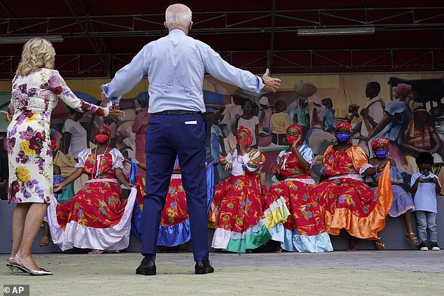 The Democratic nominee and his wife Jill stretch out their hands to the dancers who performed on the couple's visit to Miami on Monday