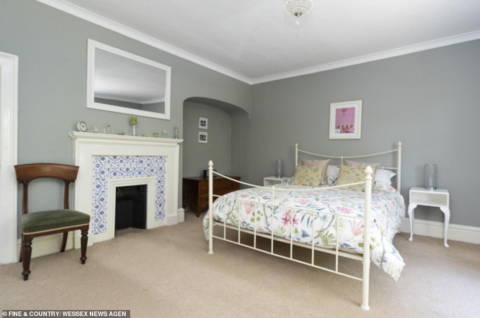 One of the five spacious bedrooms which retains its Georgian splendour with the elegant period feature fireplace