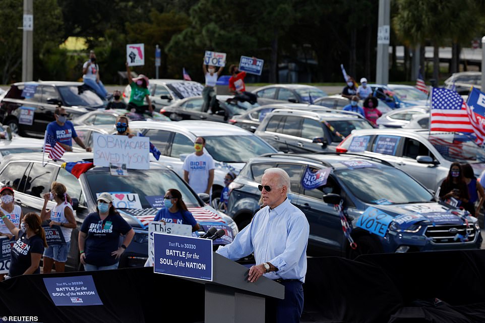 Biden was seen speaking from a podium before his socially distanced attendees who wore masks and waved American flags  from their cars at the drive-in rally in Coconut Creek, Florida on Thursday afternoon