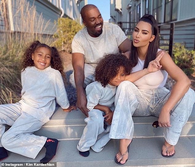 Cute: Kim Kardashian and Kanye West have once again brushed off claims that a divorce could be on the horizon as they posed for a sweet family snap on Saturday