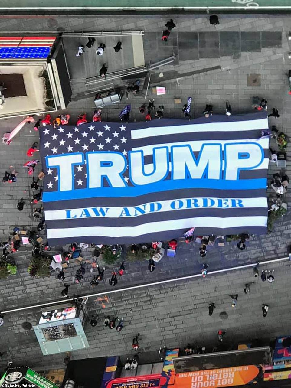 Largest Trump flag ever made is unveiled OVER the controversial BLM mural in Manhattan
