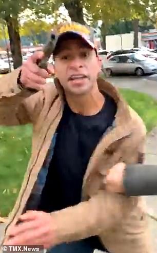 Moment MAGA supporter pulls out a gun and aims it at group of anti-Trump protesters in WA  