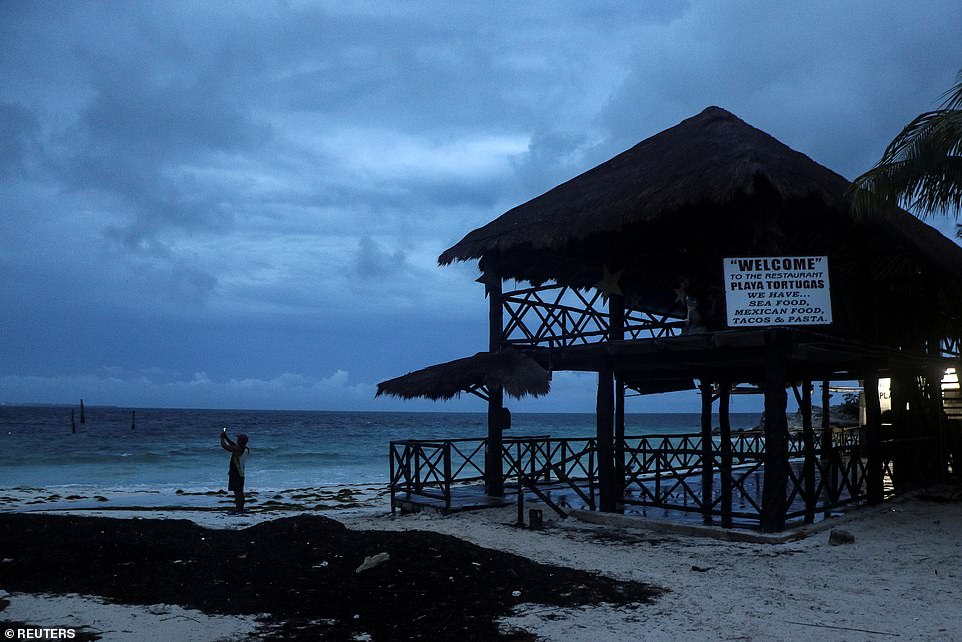 More than 30,000 tourists are evacuated and as Hurricane Delta roars towards Cancun