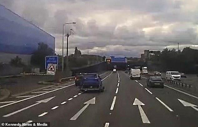 Runaway trailer carrying a car veers across busy motorway before crashing into tunnel 