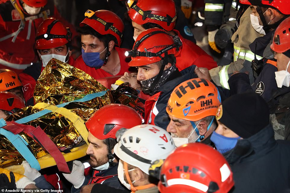 Idil Sirin, 14, who was under the rubble for 58 hours, is carried away after she was rescued from the collapsed Emrah building, Izmir