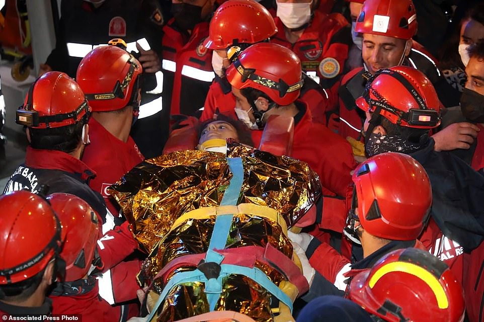 Rescue workers carry 14-year-old Idil Sirin after she was extracted from a collapsed building early on Monday in the disaster-struck city of Izmir, Turkey