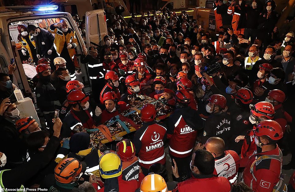 Crowds surrounded rescue workers after they freed 14-year-old Idil Sirin after 58 hours trapped in the rubble of a collapsed building in Izmir
