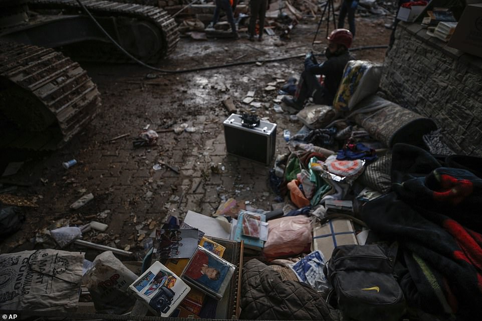 Residents' belongings can been seen in the rubble of collapsed buildings in the coastal city of Izmir, Turkey, today