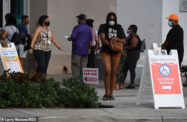 Voters wait in line Sunday during the last day of in person early voting in Miramar, Florida