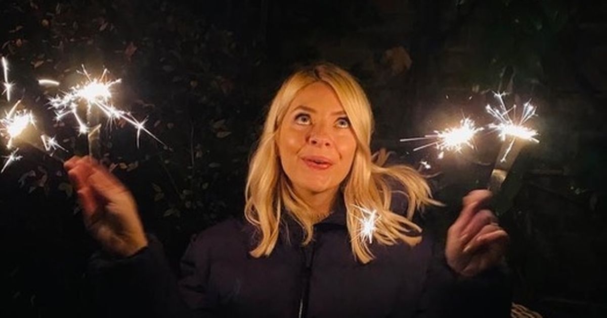 Holly Willoughby twirls sparklers as she enjoys family Bonfire Night in garden
