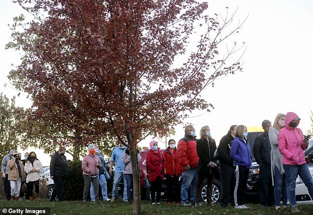 People stand in line to vote outside Bloomfield United Methodist Church on in Des Moines
