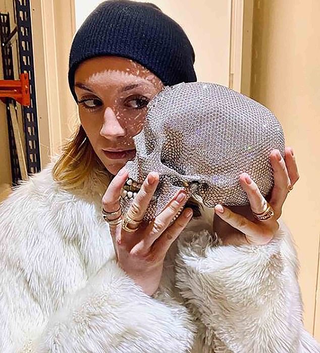 'For the Love of God' was a platinum cast human skull covered in over 8,600 diamonds which cost the artist £14 million to make. Picured, Hirst's girlfriend Sophie Cannell with the creation