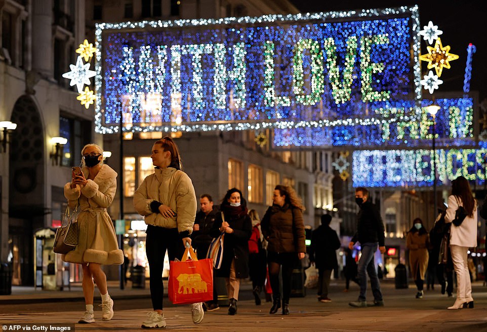 Pedestrians walk through Oxford Street, London as Britain remains in its winter lockdown